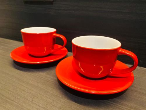 two red cups and saucers sitting on a table at Edge Central Pattaya Vip Condo in Pattaya Central