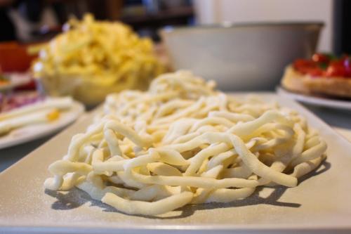 a pile of pasta on a plate on a table at Agriturismo Quarantallina in Buonconvento