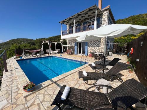 a villa with a swimming pool and a house at Alseides Villas in Chort&aacute;ta