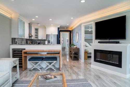 a living room with a flat screen tv on a fireplace at 2105 Bay Pointe Villa in Seabrook Island