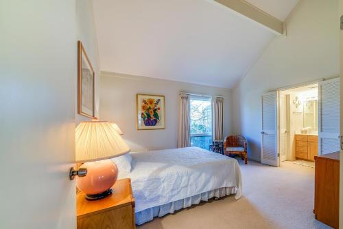 a bedroom with a bed and a lamp on a table at 325 Beach Club Villa in Seabrook Island