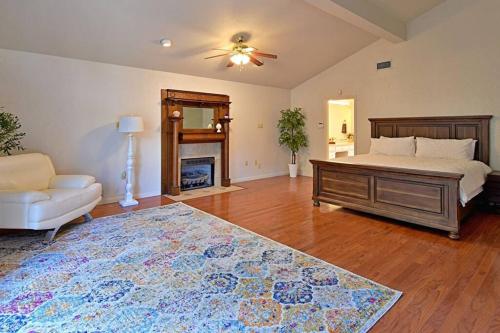 a bedroom with a bed and a fireplace and a rug at Mansion on 5ac with pool and indoor court, 5bdr, sleeps 14 in Copperas Cove