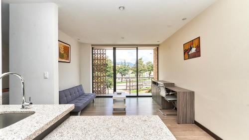 a living room with a sink and a couch at Hotel & Suites en Cuenca, Venue Batán in Cuenca