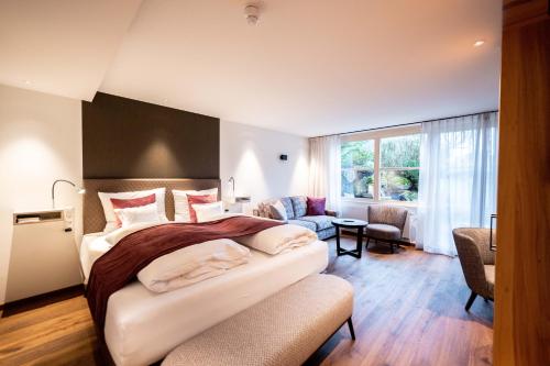 a hotel room with a large bed and a window at Hotel Zum Ochsen in Schonwald im Schwarzwald