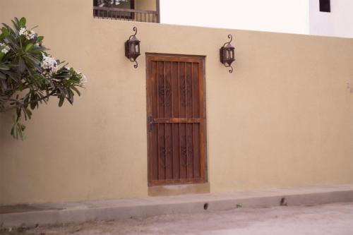 a door on the side of a building with lights at Seuia Departamentos con alberca a pasos del lago in Ajijic