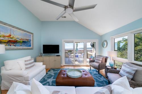 a living room with white furniture and a ceiling fan at 13108 Pelican Watch Villa in Seabrook Island