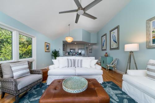 a living room with white furniture and a ceiling fan at 13108 Pelican Watch Villa in Seabrook Island