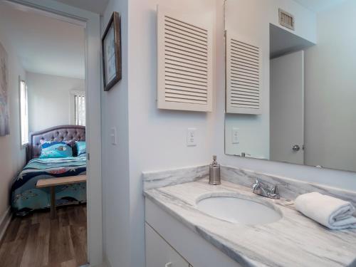 a bathroom with a sink and a mirror and a bed at 2221 Oyster Catcher Court in Seabrook Island