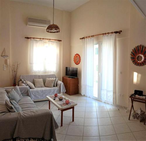 a living room with a couch and a table at Ukulele central apartment in Sami