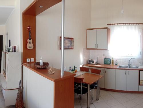 a kitchen with a refrigerator and a table in it at Ukulele central apartment in Sami
