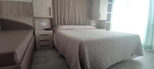 Кровать или кровати в номере Hotel Losanna Cervia