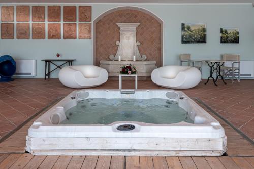 a bath tub in a room with a fountain at Locanda Poggioleone in Castiglione del Lago