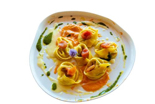 a plate of food with pasta on a white plate at Locanda Poggioleone in Castiglione del Lago