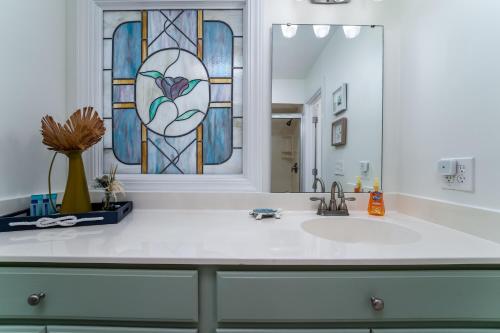 a bathroom with a sink and a stained glass window at 2123 Bay Pointe Villa in Seabrook Island