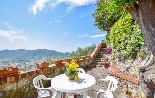 a white table and chairs on a stone wall at Casa La Borra in Camaiore