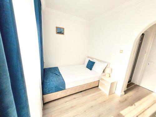 a small bedroom with a bed in a room at Guest House Kolev - central in Nesebar