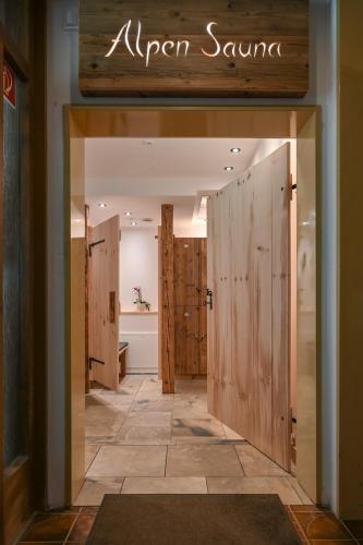 a dressing room with wooden doors in a store at Hotel Ruchti - Zeit für mich in Füssen