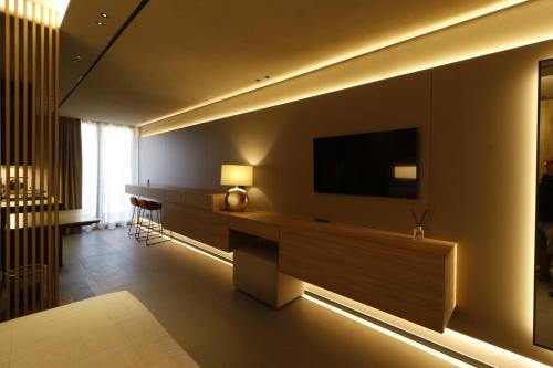 a living room with a television on a wall at Giargeri Home in Misterbianco