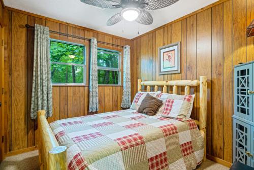 a bedroom with wooden walls and a bed in a room at Artisan Hideaway in Helen