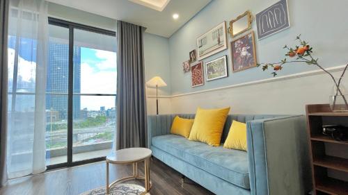 a living room with a couch and a large window at LAD Apartment & Homestay Hải Phòng - Hoàng Huy Grand Tower in Hai Phong