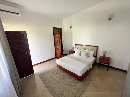 a bedroom with a bed and a wooden door at Lerailuxuryhomes 