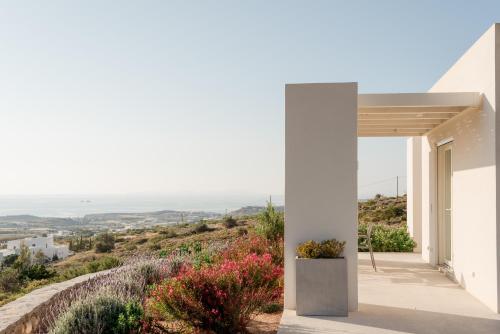 a white house with a view of the ocean at Noble 7 Suites - Adults Only - Onar Hotels Collection in Parikia
