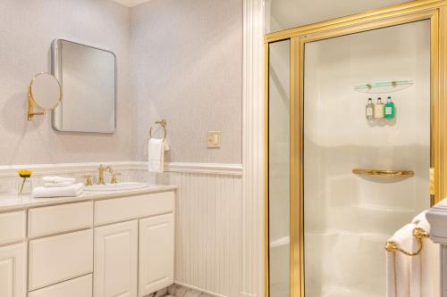 a white bathroom with a shower and a sink at The Wentworth in Jackson