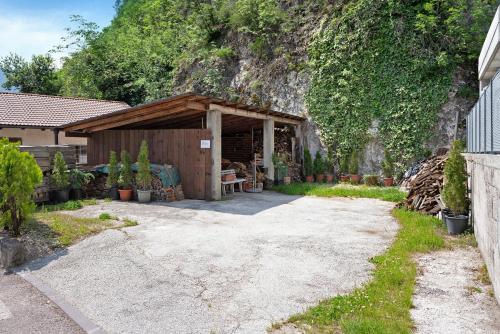 a shed with a bench in front of a mountain at Haus Weinblick Apt 3 in Magrè allʼ Adige