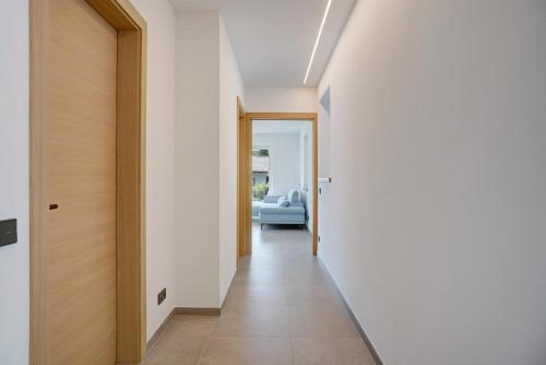 a hallway leading to a living room with a blue couch at Haus Weinblick Apt 3 in Magrè allʼ Adige
