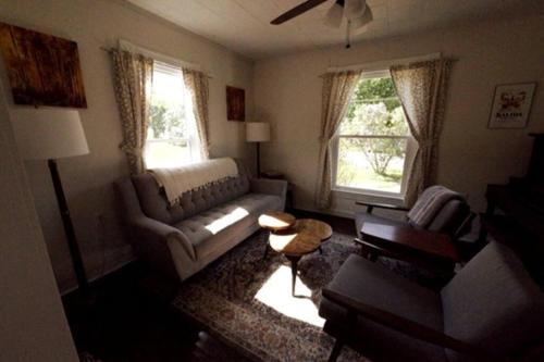 a living room with a couch and a table at FLX 1890's Farmhouse in Hector