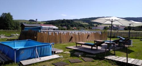 a picnic table and an umbrella in a yard at chalets les 5 loups in Gerbépal