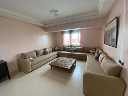 a living room with a couch and a coffee table at view apartments larache in Larache