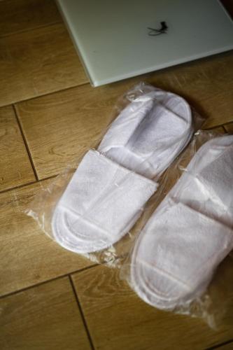 a pair of white shoes sitting on a floor at Bogolvar Retreat Resort in Antonovka