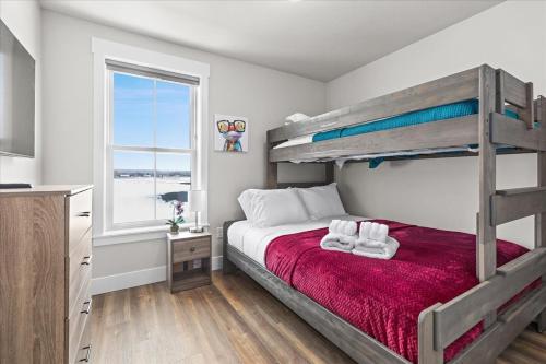 a bedroom with a bunk bed and a window at Stay With Style In This Townhome in Billings