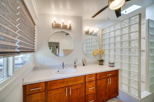 a bathroom with a sink and a mirror at Updated Poipu Home Large Deck with Scenic View in Koloa