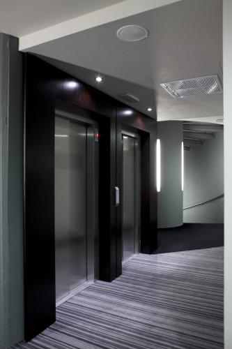 an empty hallway with glass doors in a building at Twentyone Hotel in Rome