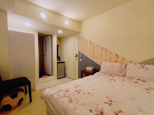 a bedroom with a bed with a soccer ball on it at 逢甲晨熙 in Taichung