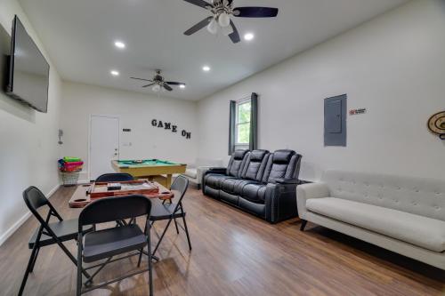 a living room with a couch and a table and chairs at Hot Tub and 2 Game Rooms Family Poconos Getaway! in Pocono Summit