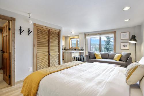 a bedroom with a large white bed and a couch at Studio @ The Village w/Incredible Views~Sleeps 4 in Breckenridge