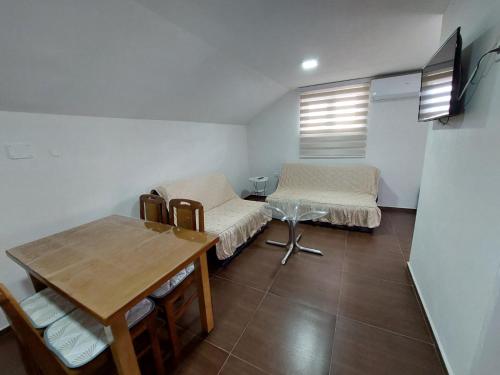 a room with two beds and a table in it at Vožd in Kladovo