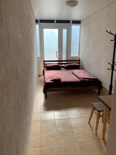 a bedroom with a bed in a room with a window at Mega city in Kyiv