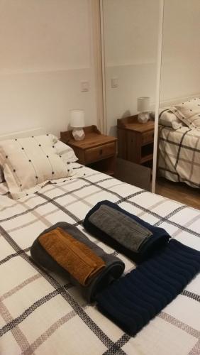 a bedroom with two beds with towels on the bed at El pisito de Malasaña in Madrid