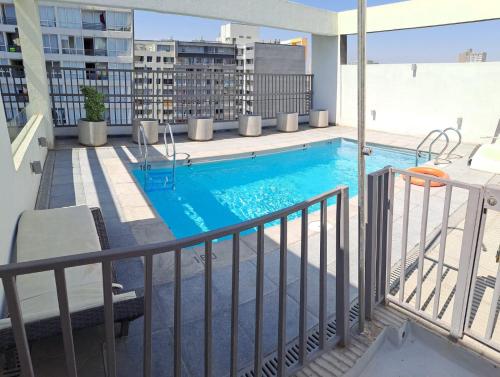 a swimming pool on the balcony of a apartment at Departamento equipado (santiago) in Santiago