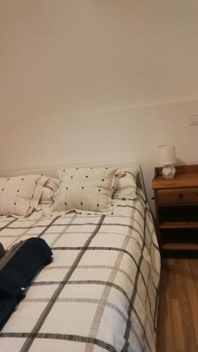 a bedroom with a bed and a nightstand with a bed sidx sidx at El pisito de Malasaña in Madrid