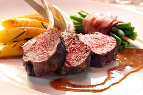 a plate of food with meat and fruits and vegetables at Schäfle Feldkirch-Altenstadt in Feldkirch