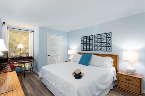 a bedroom with a bed with a hat on it at 1305 Pelican Watch Villa in Seabrook Island