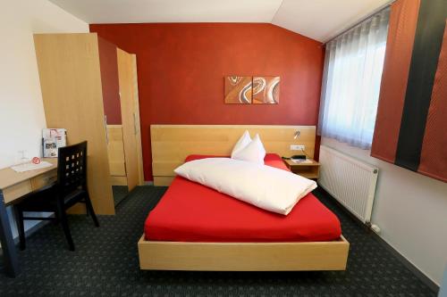a hotel room with a bed and a desk and a desk at Schäfle Feldkirch-Altenstadt in Feldkirch