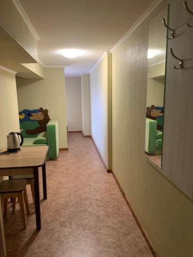 a hallway with a table and chairs in a room at Mega city in Kyiv