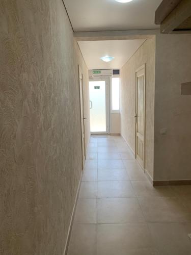 an empty hallway with a wall with a tile floor at Mega city in Kyiv