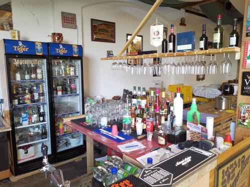 un bar con un montón de botellas de alcohol en Campingfass im Ruheparadies, en Göda